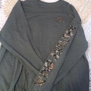 A long sleeve green camouflage shirt.